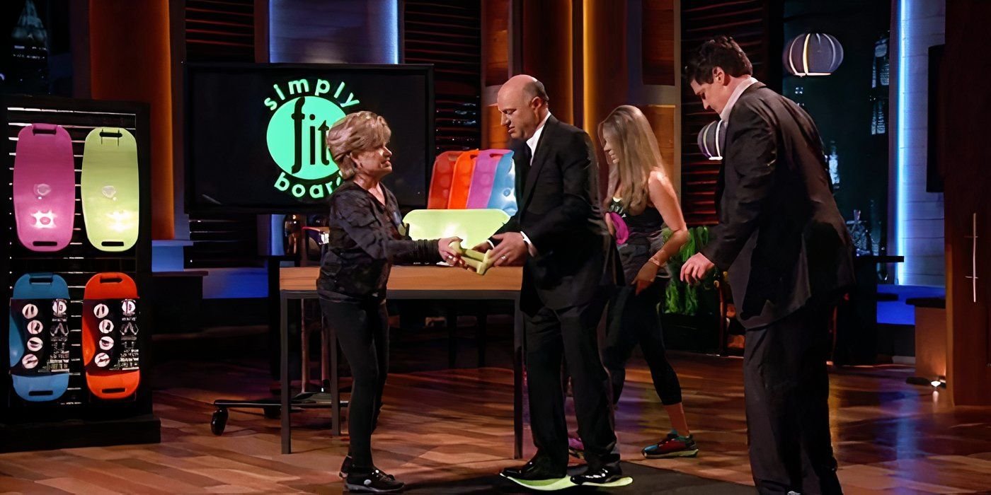 The owners of Simply Fit Board helping Kevin O'Leary and Mark Cuban try them out during the pitch on Shark Tank.