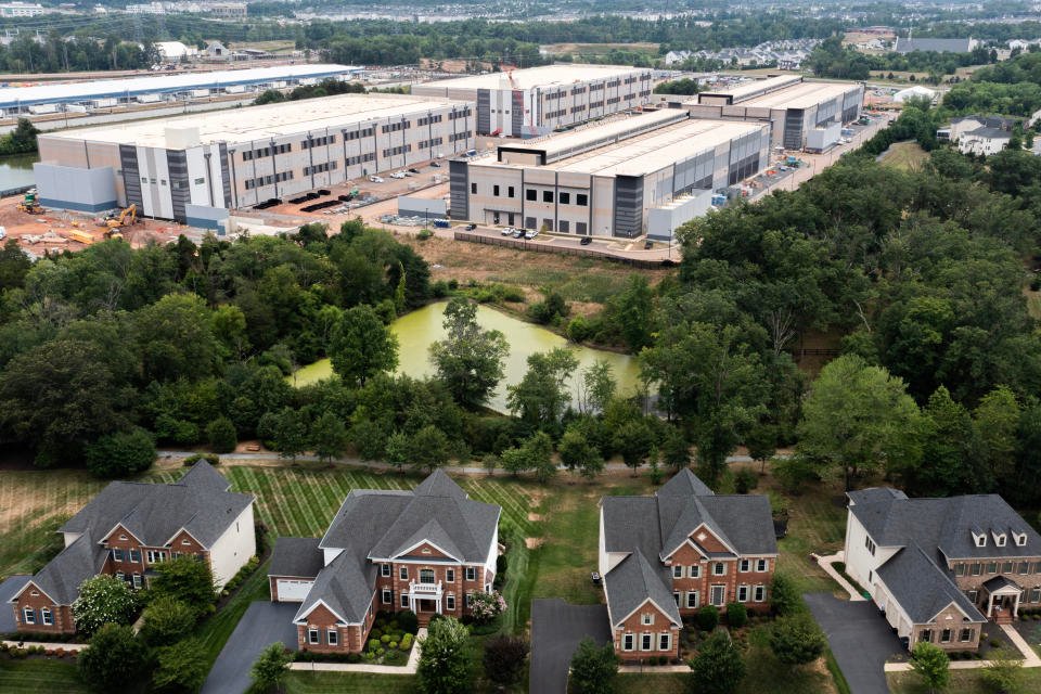 STONE RIDGE, VIRGINIA - JULY 17:  In an aerial view, an Amazon Web Services data center is shown situated near single-family homes on July 17, 2024 in Stone Ridge, Virginia. Northern Virginia is the largest data center market in the world, according to a report this year cited in published accounts, but is facing headwinds from availability of land and electric power. (Photo by Nathan Howard/Getty Images)