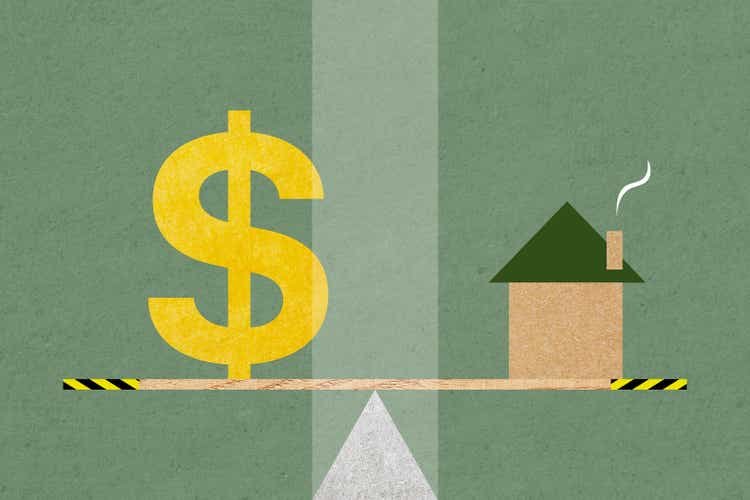 A house and a dollar symbol balanced on a seesaw