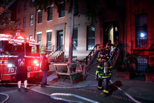 Firefighters run a hose through the parlor floor to get to a fire that broke out on the terrace of a brownstone on Henry Street in Brooklyn Heights on Oct. 13. Photo courtesy of Marc Hermann