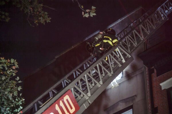 Firefighters climb a ladder to the roof of the Brooklyn Heights brownstone in the early morning hours of Oct. 13. Photo courtesy of Marc Hermann