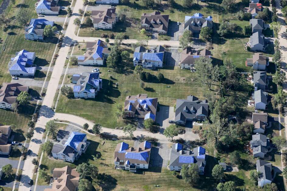 An Aug. 21, 2020, photos shows blue tarps on damaged roofs in north Cedar Rapids following the Aug. 10 derecho. More than 1,000 homes in Cedar Rapids were deemed “unsafe to occupy” after the storm. Damage caused by storms and wildfires in the U.S. have pushed home insurance rates higher, with some companies dropping policies because of the increased risk posed by climate change.  (The Gazette)