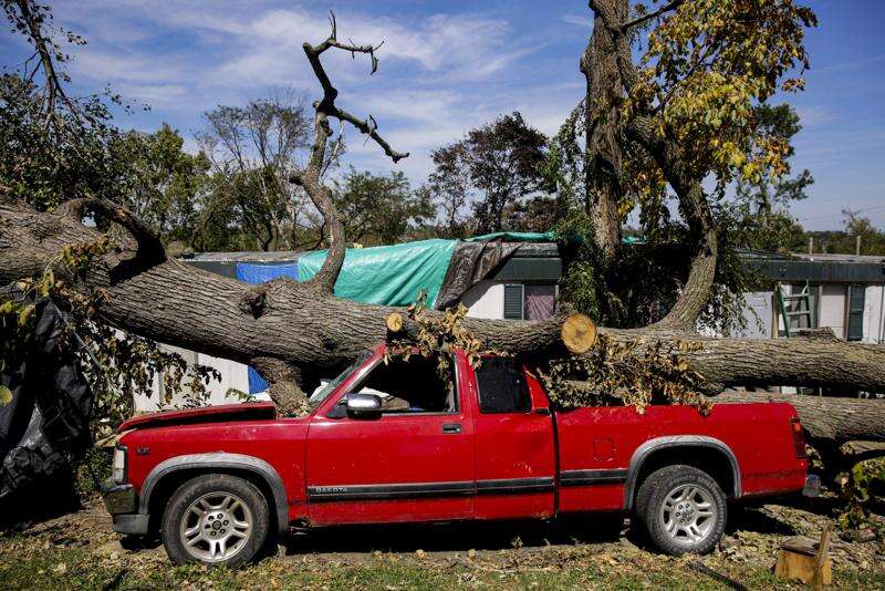 A truck crushed by a fallen tree is seen Aug. 20, 2020, alongside Carmen Baker's mobile home at Edgewood Forest mobile home park in Cedar Rapids. Baker’s home also was heavily damaged in the Aug. 10 storm. (The Gazette)