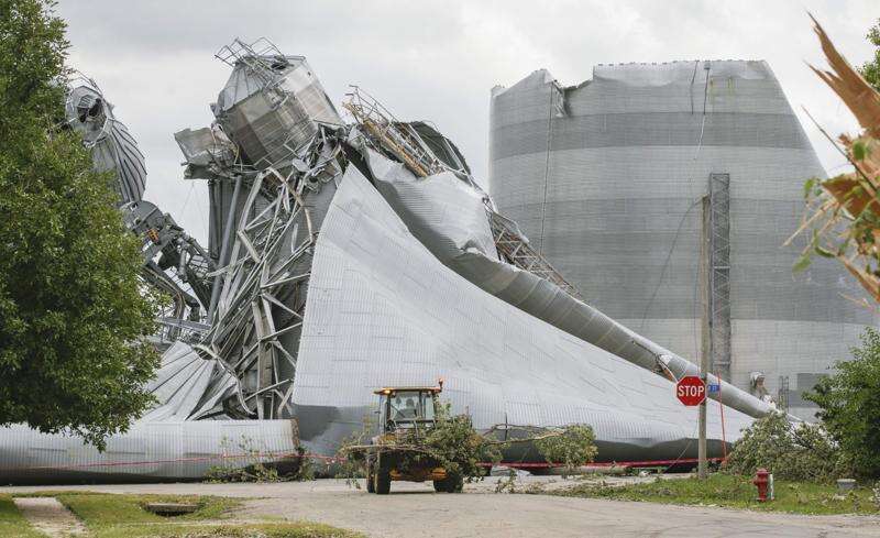 Iowa Department of Transportation workers remove tree debris Aug. 12, 2020, from around the Archer Daniels Midland plant in Keystone, where the Aug. 10 storm crushed grain bins.  (Jim Slosiarek/The Gazette) 