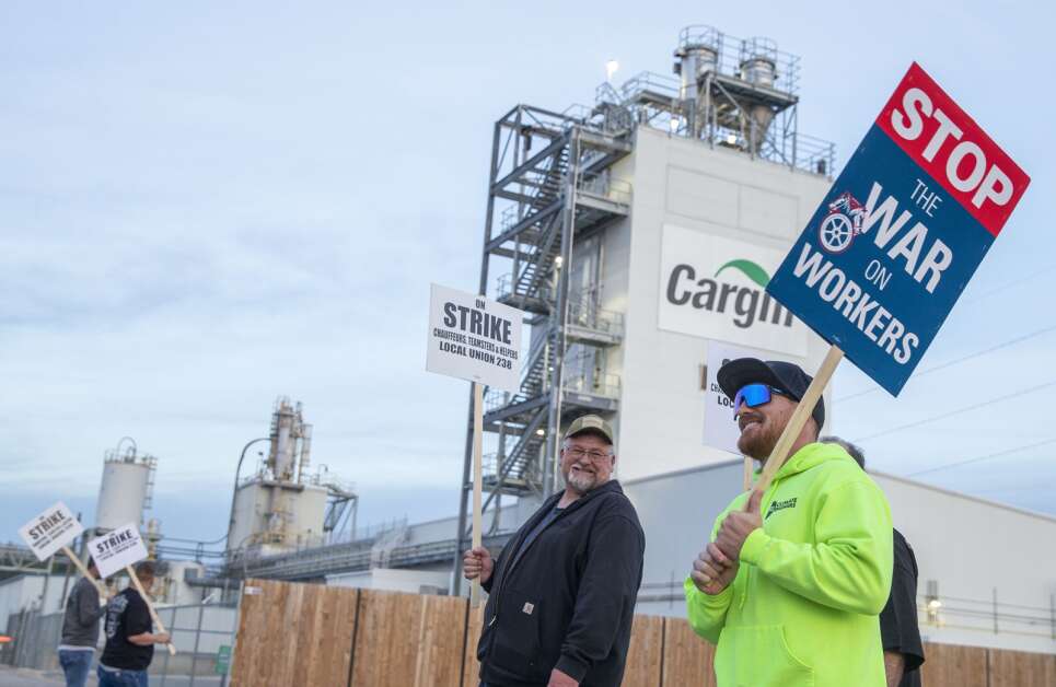 Local Union 238 member Wayne Masters, left, and Tyler Hilleshsiem, right, talk with each other while picketing together Oct. 1 outside the Cargill corn milling plant in southeast Cedar Rapids. Hilleshsiem has been an employee at Cargill for over 10 years. (Savannah Blake/The Gazette)