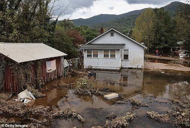 Recent natural disasters have exposed how few Americans have flood insurance, and the potentially devastating impact this can have (Pictured: Floodwaters remaining from Hurricane Helene in Swannanoa, North Carolina)