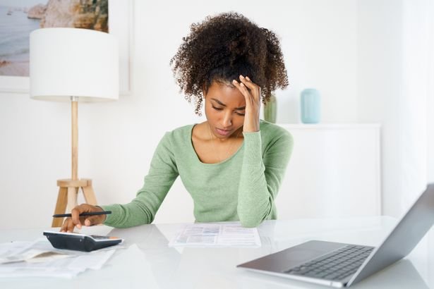 Unhappy black woman feel stressed working on computer at home