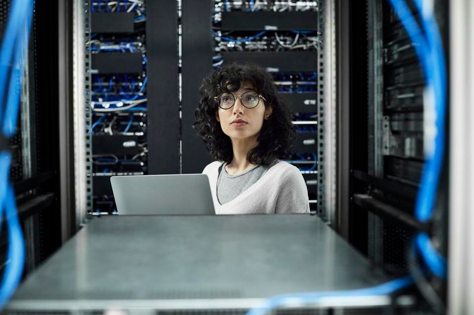 Female technician standing in server room