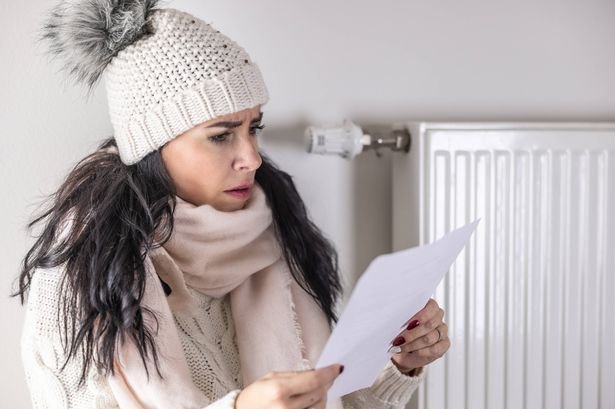  woman is shocked from the rising energy costs and the bill she received for heat and electricity for her household.