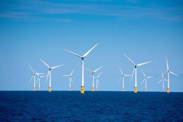 Wind turbines at London Array offshore wind park, North Sea, near England on a sunny day