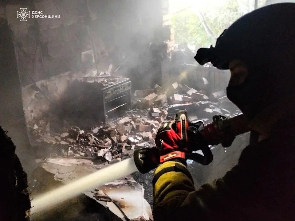A firefighter at a residential house damaged by a Russian strike on Kherson (Ukrainian Emergency Service)