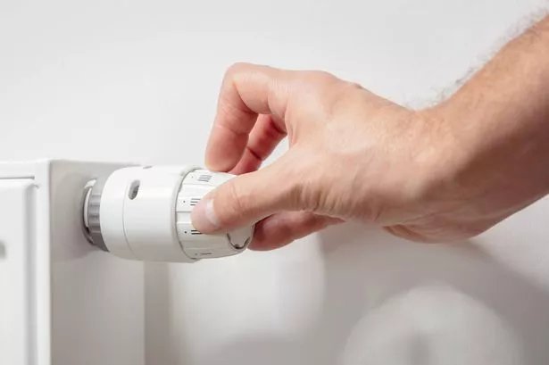 Adjusting temperature on home radiator thermostat central heating control adjustment background