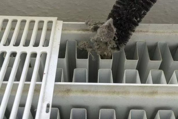 Cleaning a radiator full of dust
