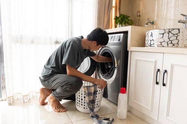 Man taking laundry out of the washing machine