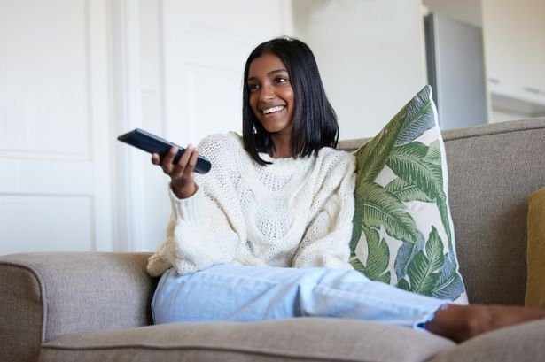 Woman watching tv in living room
