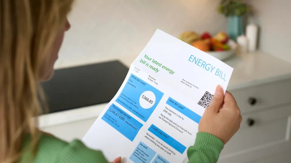 Close Up Of Woman Opening American Dollar Energy Bill During Cost Of Living Crisis