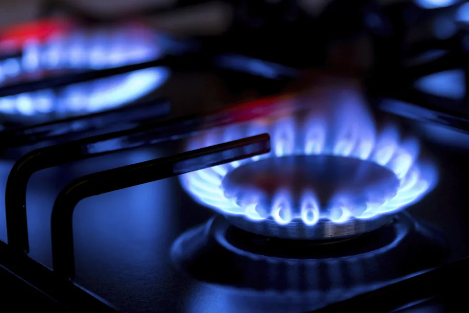 Gas burner with burnig blue methane on dark background