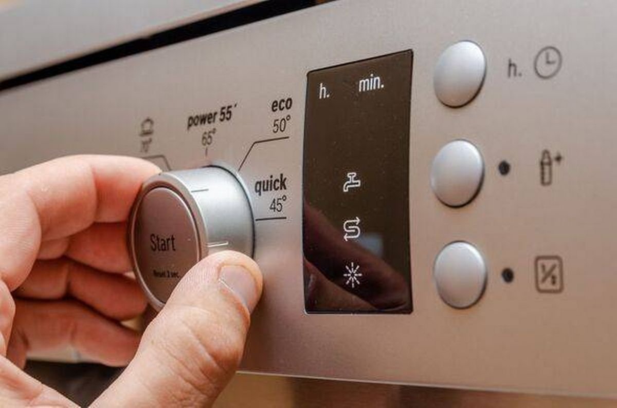 man's hand sets in stylish gray dishwasher control