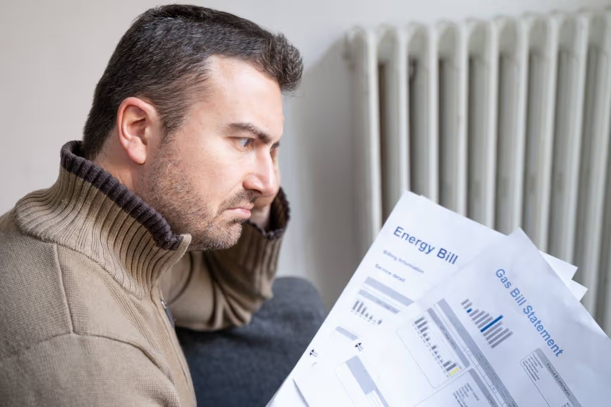One man worried about bills reading home heating utilities increase costs