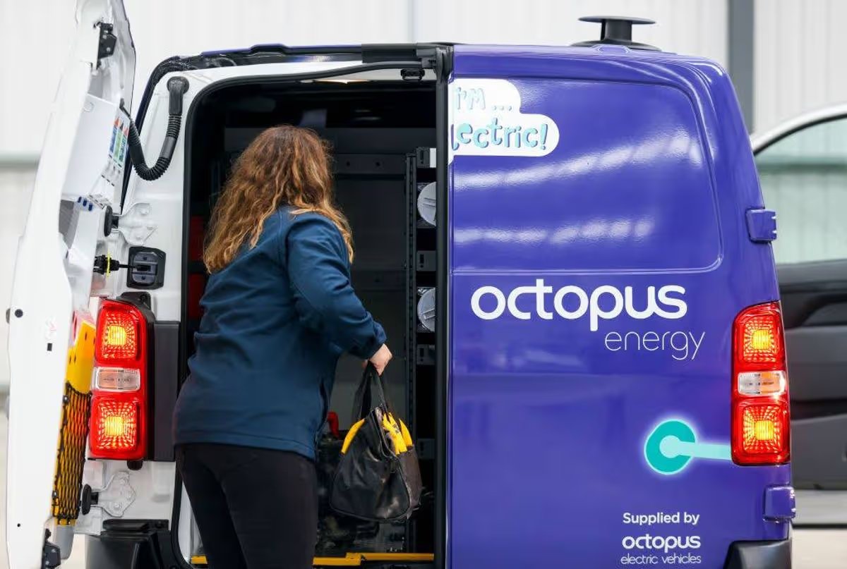 An individual, dressed in a blue jacket and black pants, is entering a delivery van with the brand name "Octopus" prominently displayed on its side. The van's rear door is open, revealing a well-organized interior.