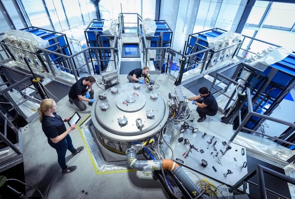 Scientists checking large pulsed power machine which creates nuclear fusion in nuclear fusion research facility