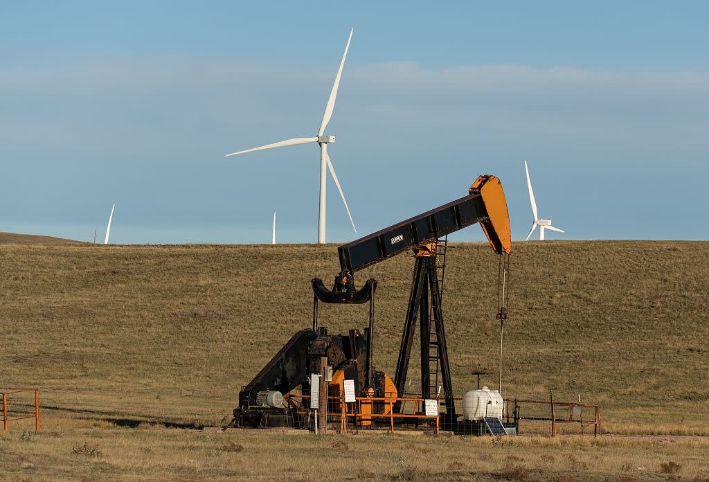 Oil pump jack and windmills, southern Wyoming —Marli Miller/UCG/Universal Images Group—Getty Images