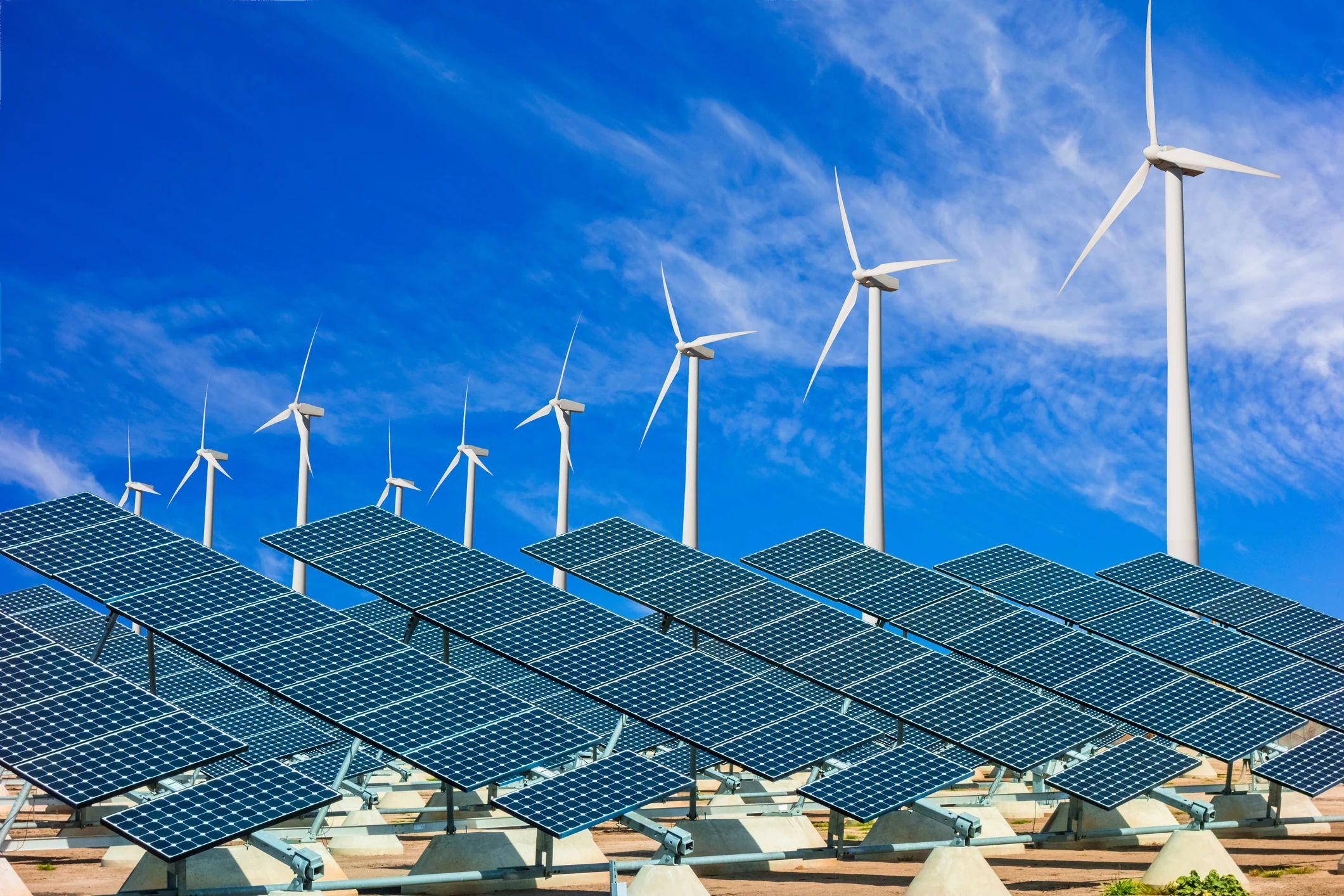 Wind turbines and solar panels renewable energy green.