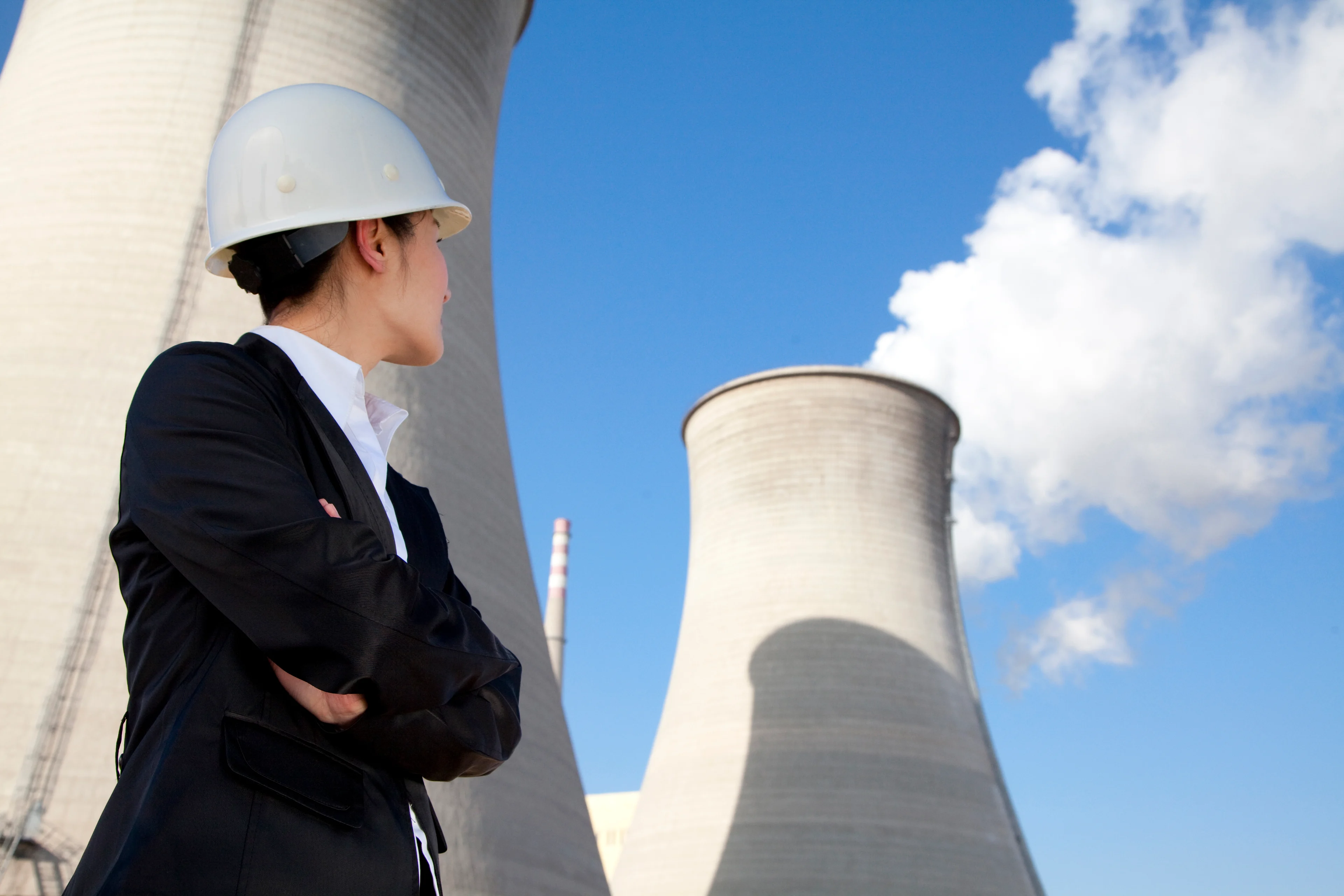 A worker outside a nuclear power facility.