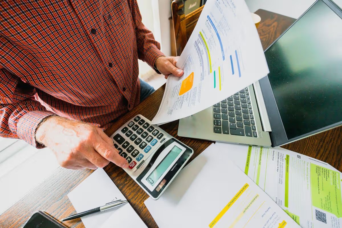 A man holding energy bills