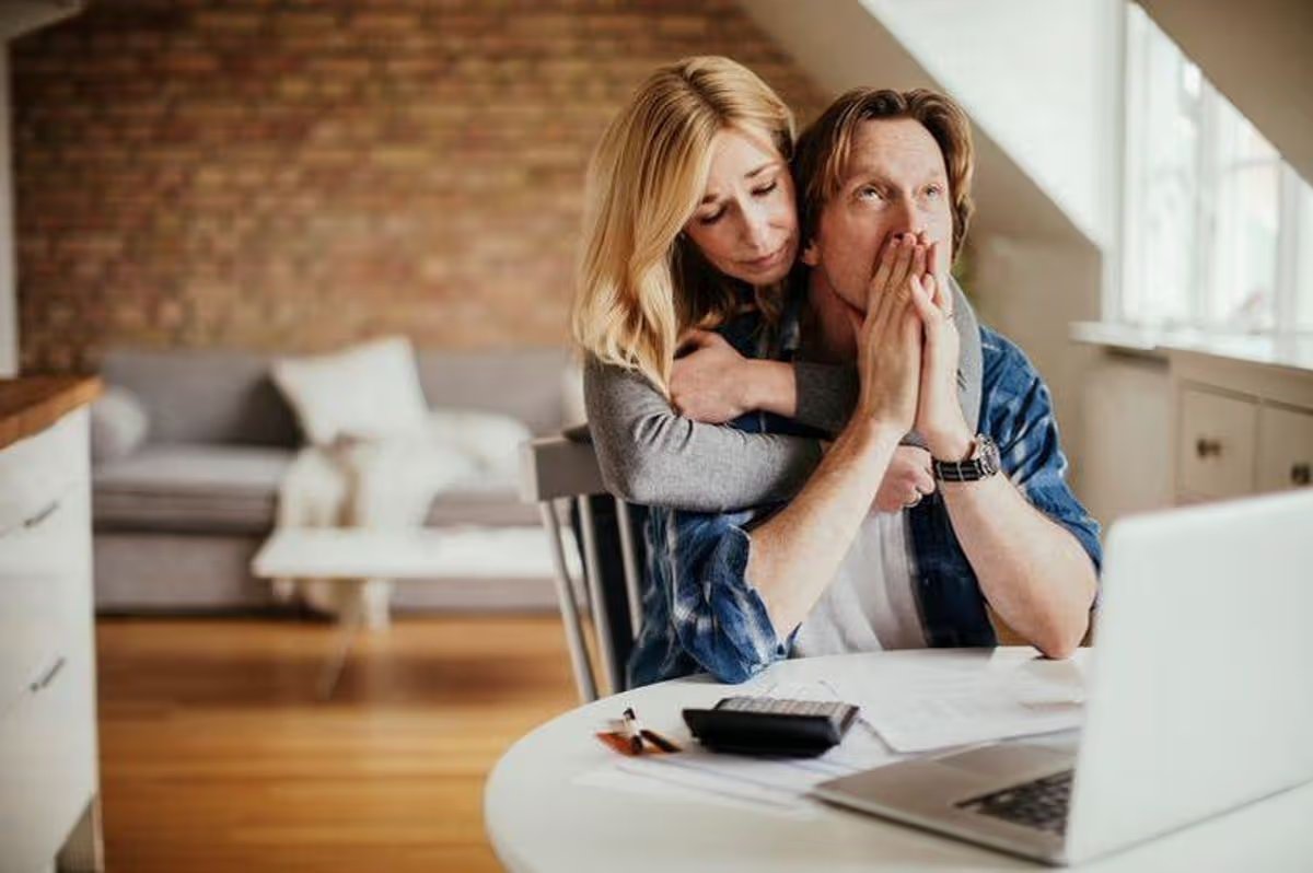 A worried looking man and woman are offering each other comfort. 