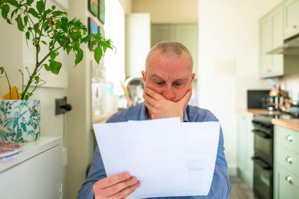 Person reading a letter in shock