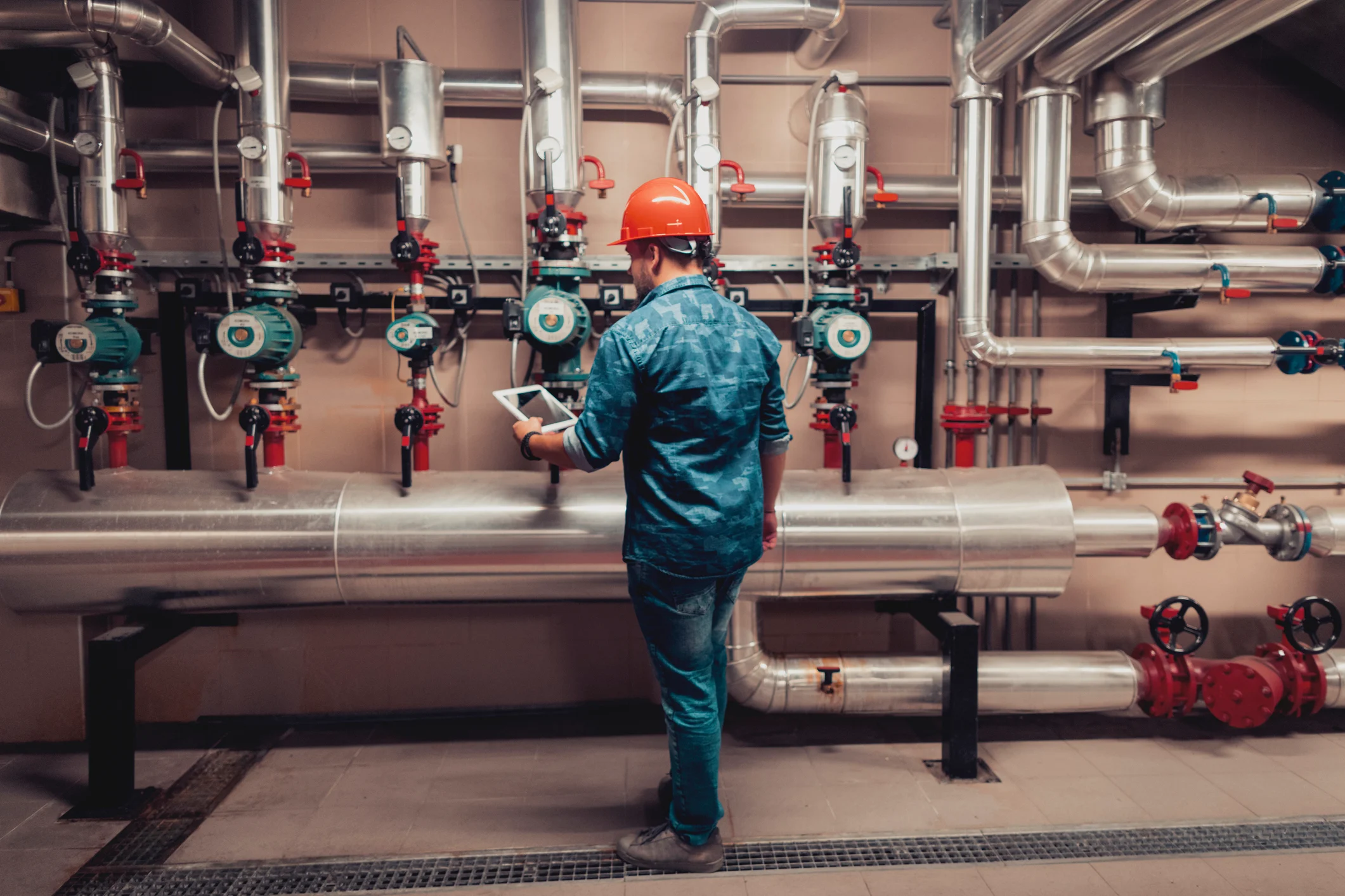 Worker examines pipelines.