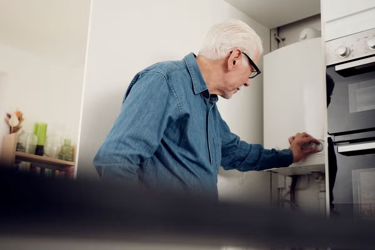 A man adjusting his boiler settings
