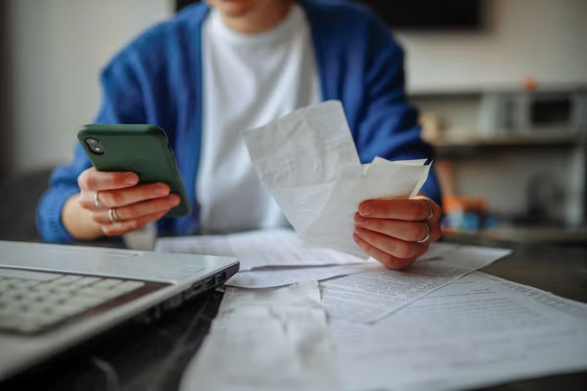 Someone with receipts looking at bills