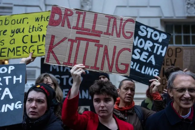 LONDON, ENGLAND - OCTOBER 21: Activists protest outside the Department for Energy Security and Net Zero (DESNZ) on October 21, 2026 in London, England. Climate campaigners from Fossil Free London are protesting the government's approval of the Jackdaw gas field project in the North Sea. (Photo by Carl Court/Getty Images)